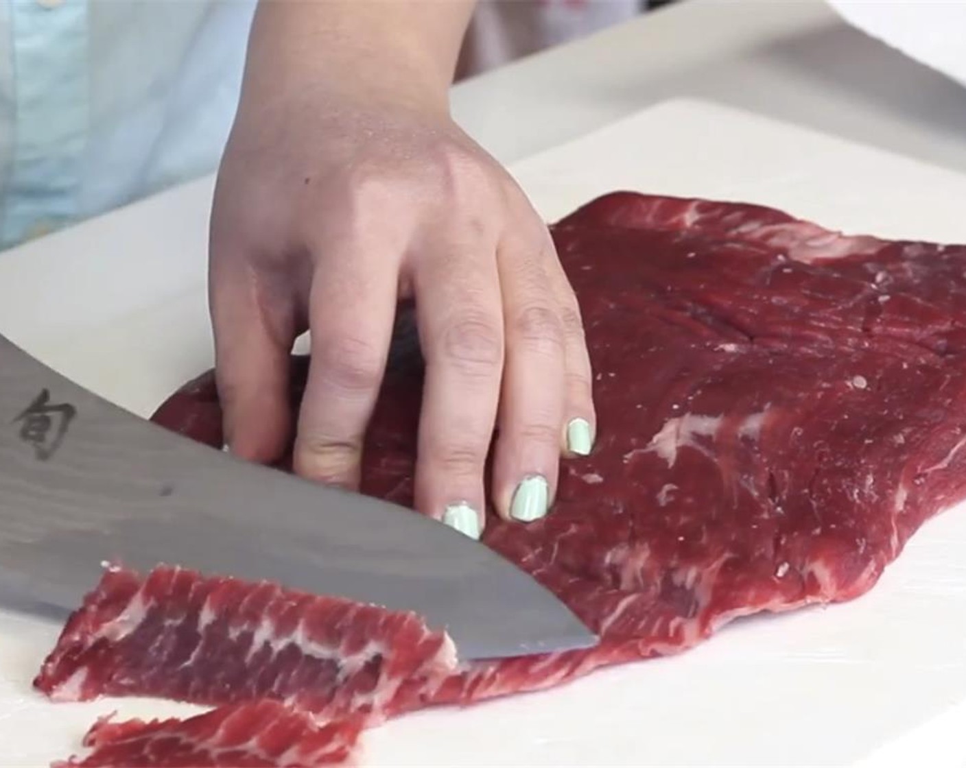 step 1 Slice the Flank Steak (1.5 lb) against the grain into 1/2-inch thick slices with your knife at an angle.