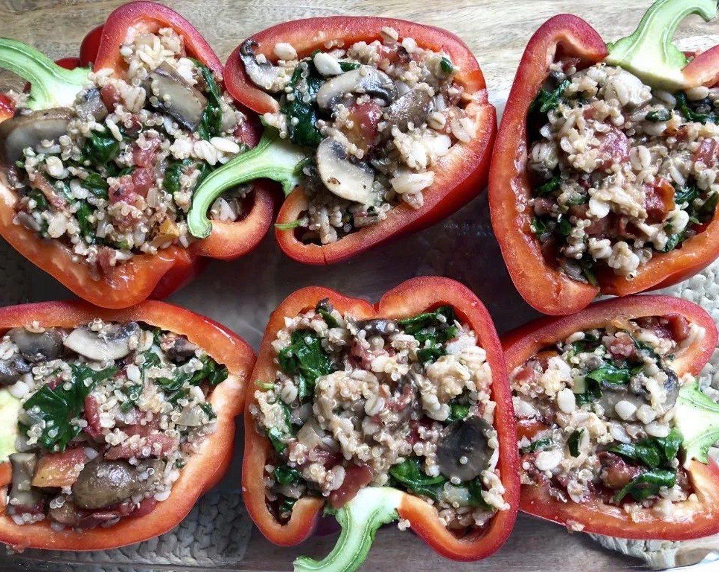 step 8 Fill pepper halves with quinoa mixture. Place peppers, filled sides up, in a three-quart rectangular baking dish.  Pour the reserved cooking liquid into dish around peppers.