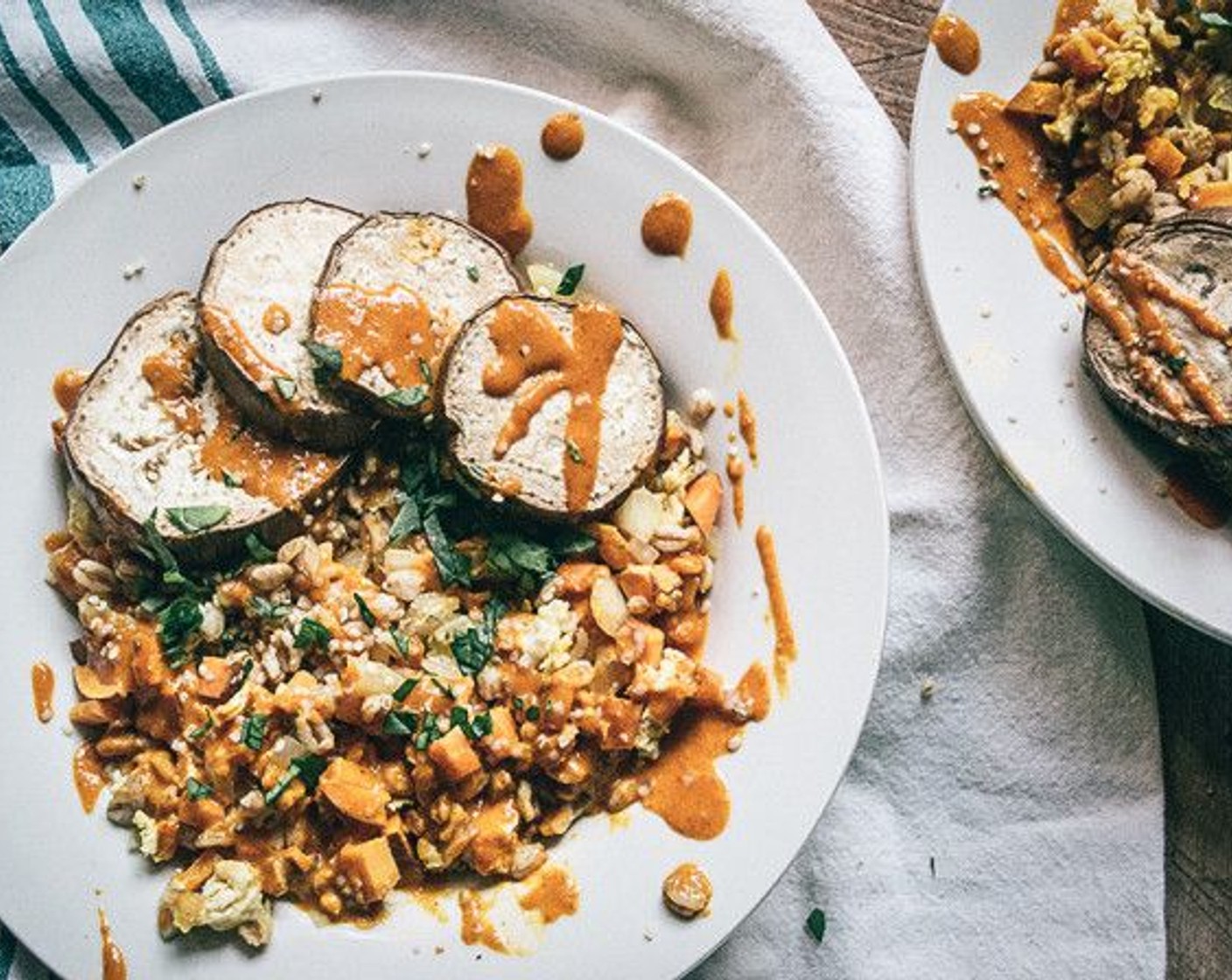 step 10 Divide fried "rice" farro into two bowls, top with roasted eggplant, then drizzle with Sriracha Cashew Cream Sauce and garnish with Hemp Hearts (1 tsp) and Fresh Herbs (to taste).