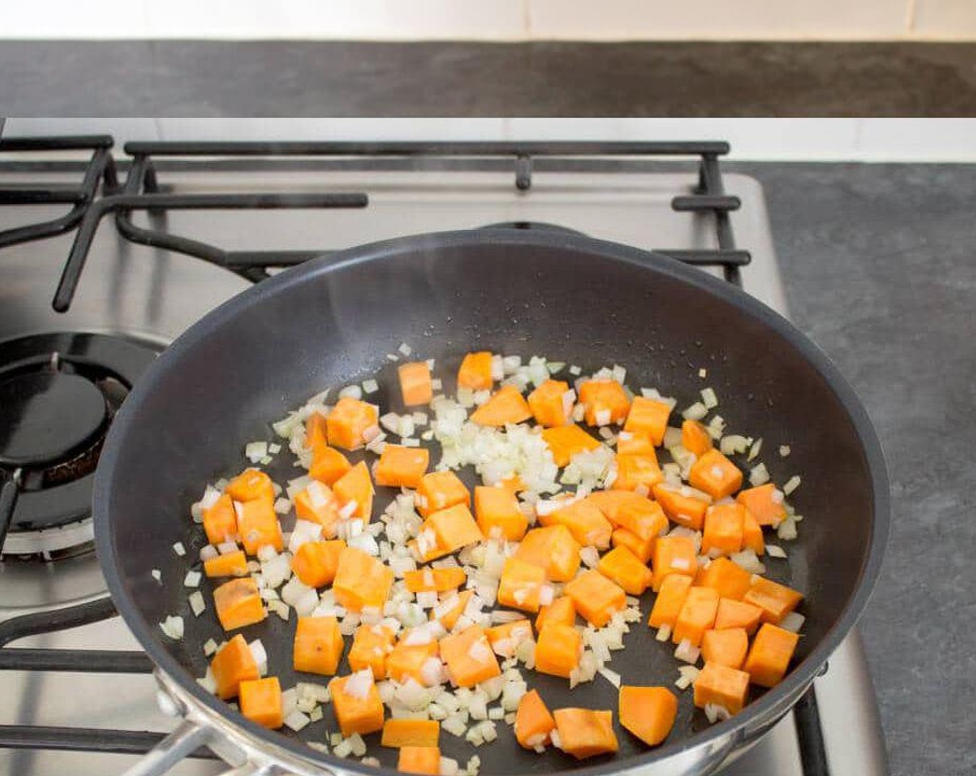 step 2 Heat a non-stick frying pan over medium heat then add in about 1 tbsp of olive oil. Dump in the Sweet Potato (1) and fry for a few minutes. Then add in the Shallot (1) and Garlic (1 clove) and fry for about 10 to 15 minutes until the potato is golden and cooked. Soft in the middle. Season to taste with salt & pepper.