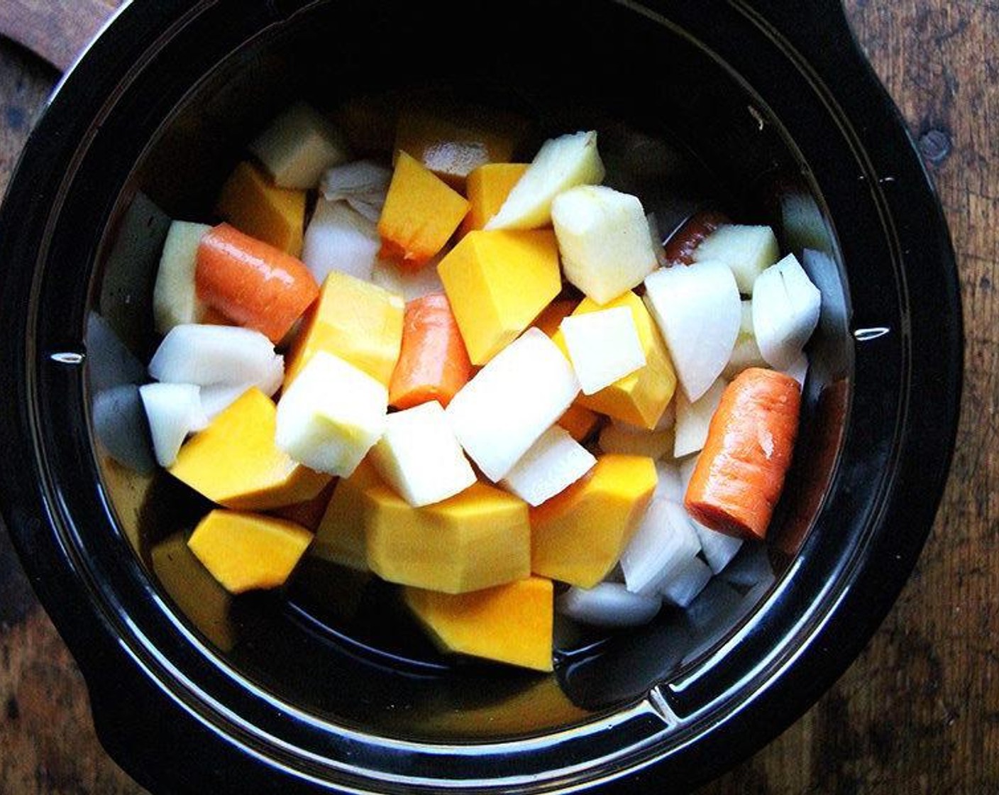 step 1 Place the Butternut Squash (6 1/2 cups), Onion (1), Apple (1), Carrot (1), and Water (2 1/2 cups) in a slow cooker. Add Kosher Salt (1 tsp). Cover and cook on high for 4 hours or on low for 8 hours, until the squash and carrots are cooked through.