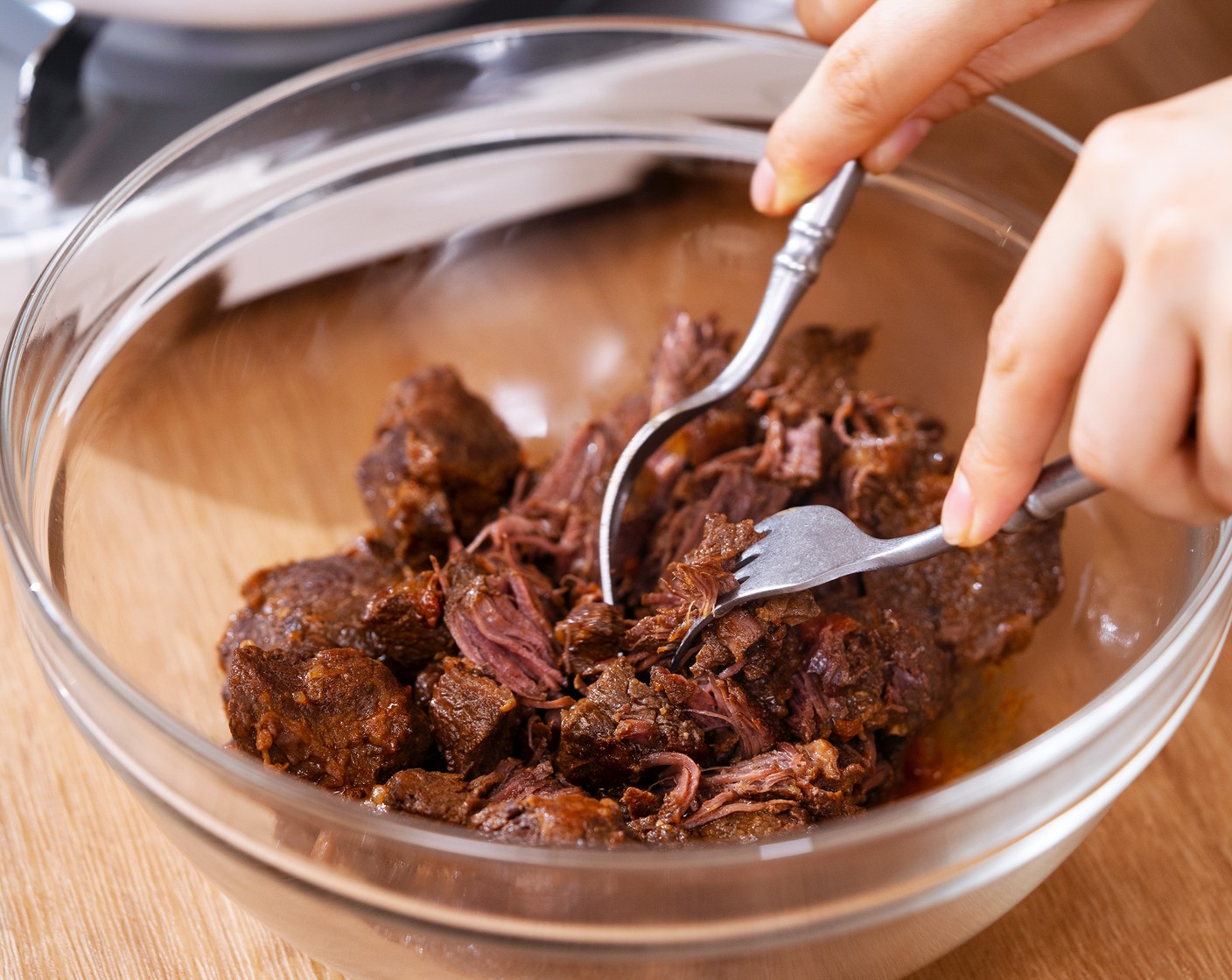 step 8 Place meat in a heatproof bowl, shred and return to the pot.