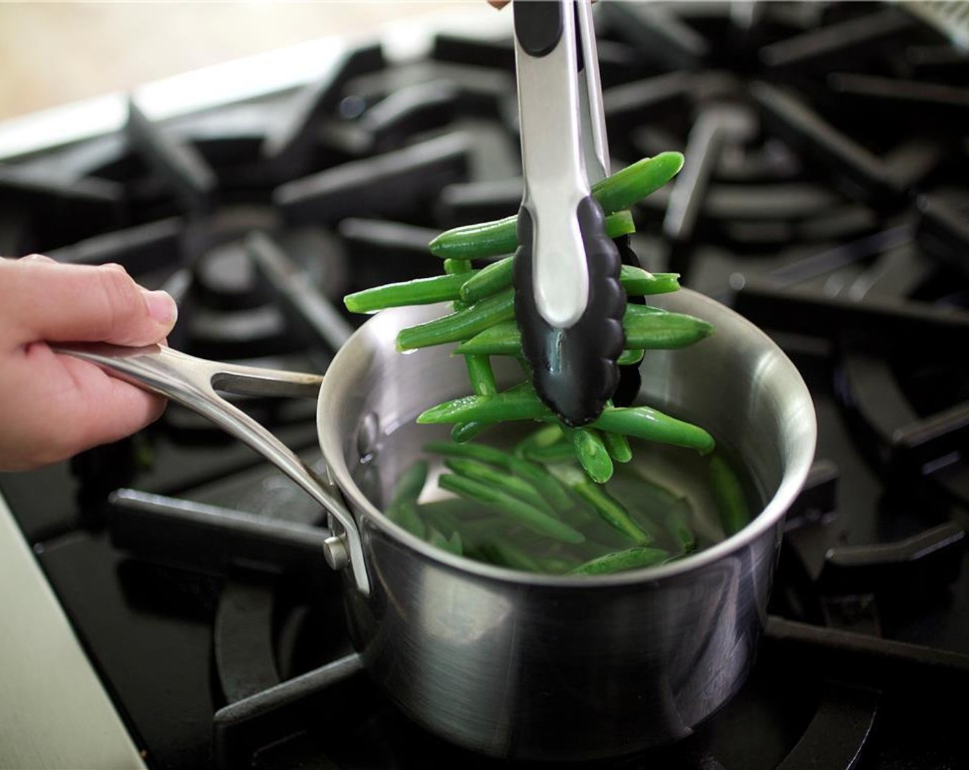step 12 Trim the ends off of the green beans and add to saucepan once water is boiling. Cook for two minutes.