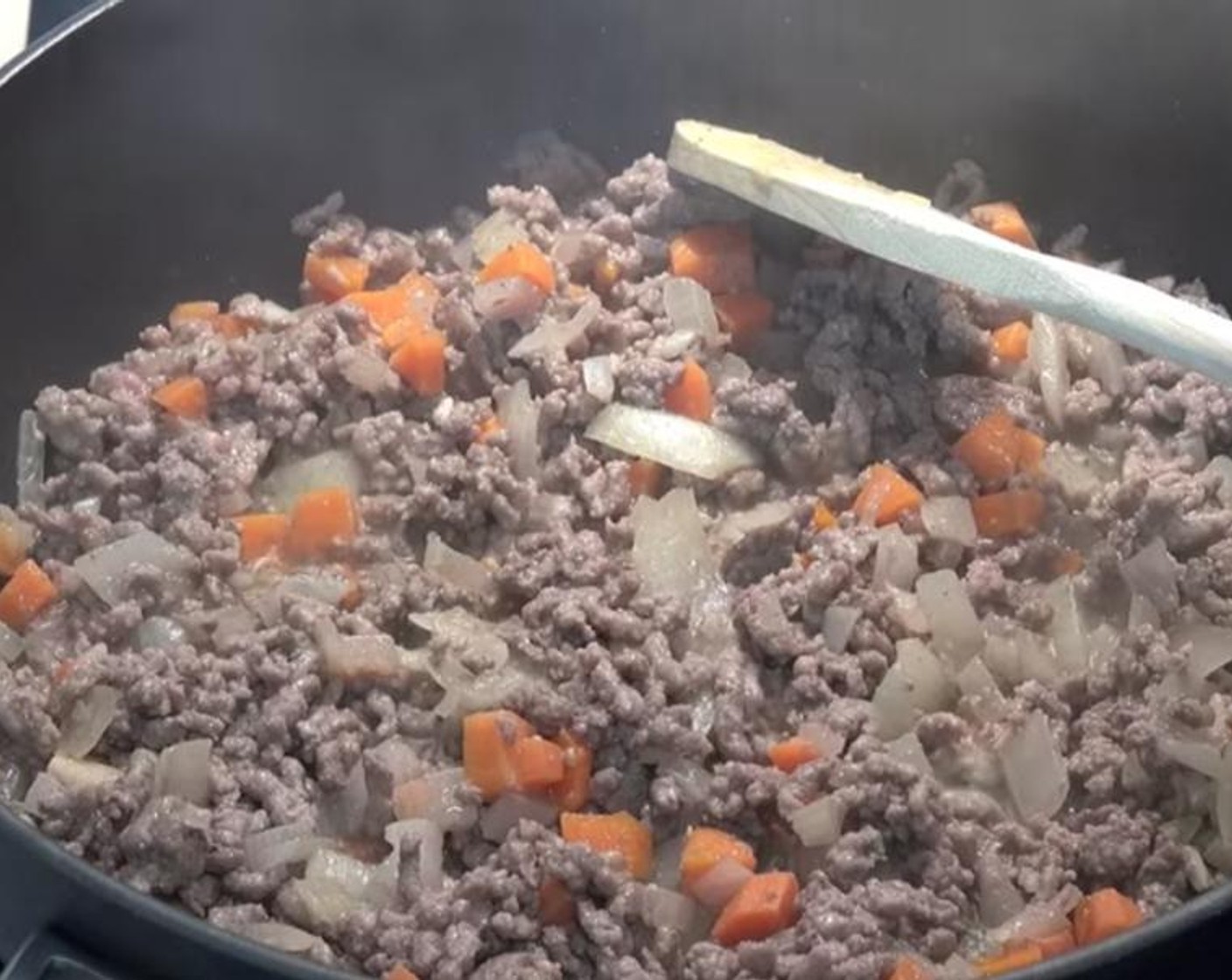 step 2 Add Garlic (2 cloves) and Ground Beef (1.1 lb). Break up beef with a spoon and cook while stirring for 5 to 10 minutes, or until beef is browned.