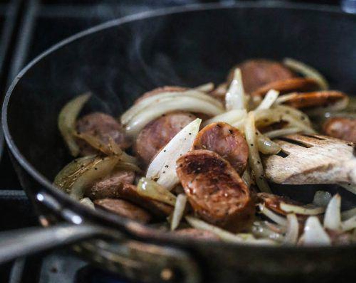 step 1 In a medium skillet preheated to medium-high heat, add the Olive Oil (1 Tbsp), Cajun Style Smoked Sausages (4), and Yellow Onion (1 cup). Sauté until the onion has softened; about four minutes.