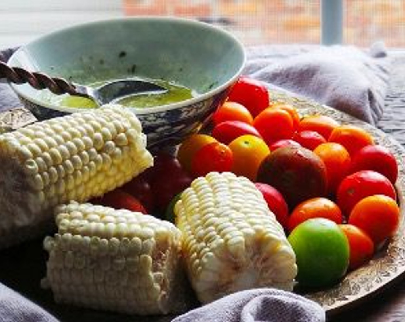 step 7 Remove from the oven, toss in the Cherry Tomatoes (2 cups) and Corn (3 ears). Baste the chicken with the Olive Oil (3 Tbsp), then drizzle remaining butter over vegetables. If you want to add in more onions, add them too!