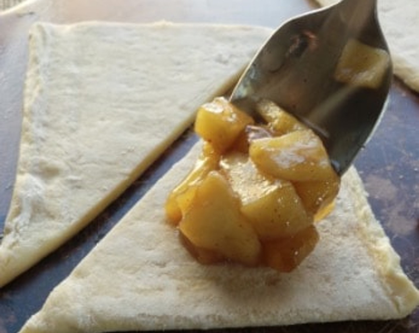 step 6 Prepare the turnovers by spooning filling into half of the triangles, then topping with the matching remaining half. Seal the edges with a fork, brush with the Egg (1) then bake for 15 minutes or until puffy and golden.