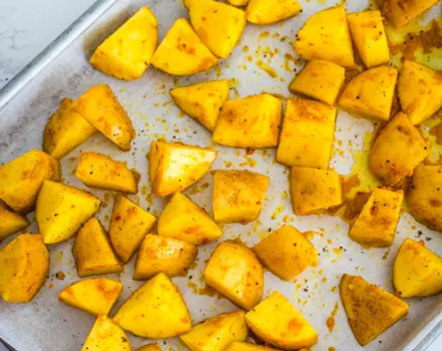 step 5 Spread the potatoes on a baking tray in a single layer over parchment paper, then top with Freshly Ground Black Pepper (to taste).