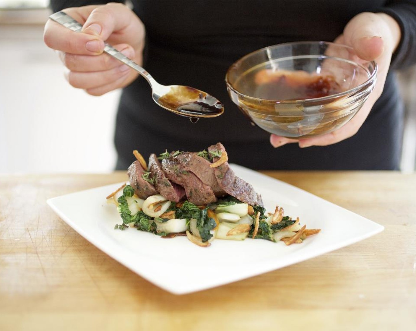 step 14 Fan out the slices of steak on top of the choy sum. Drizzle the garlic-soy infusion over the steak. Serve and enjoy!