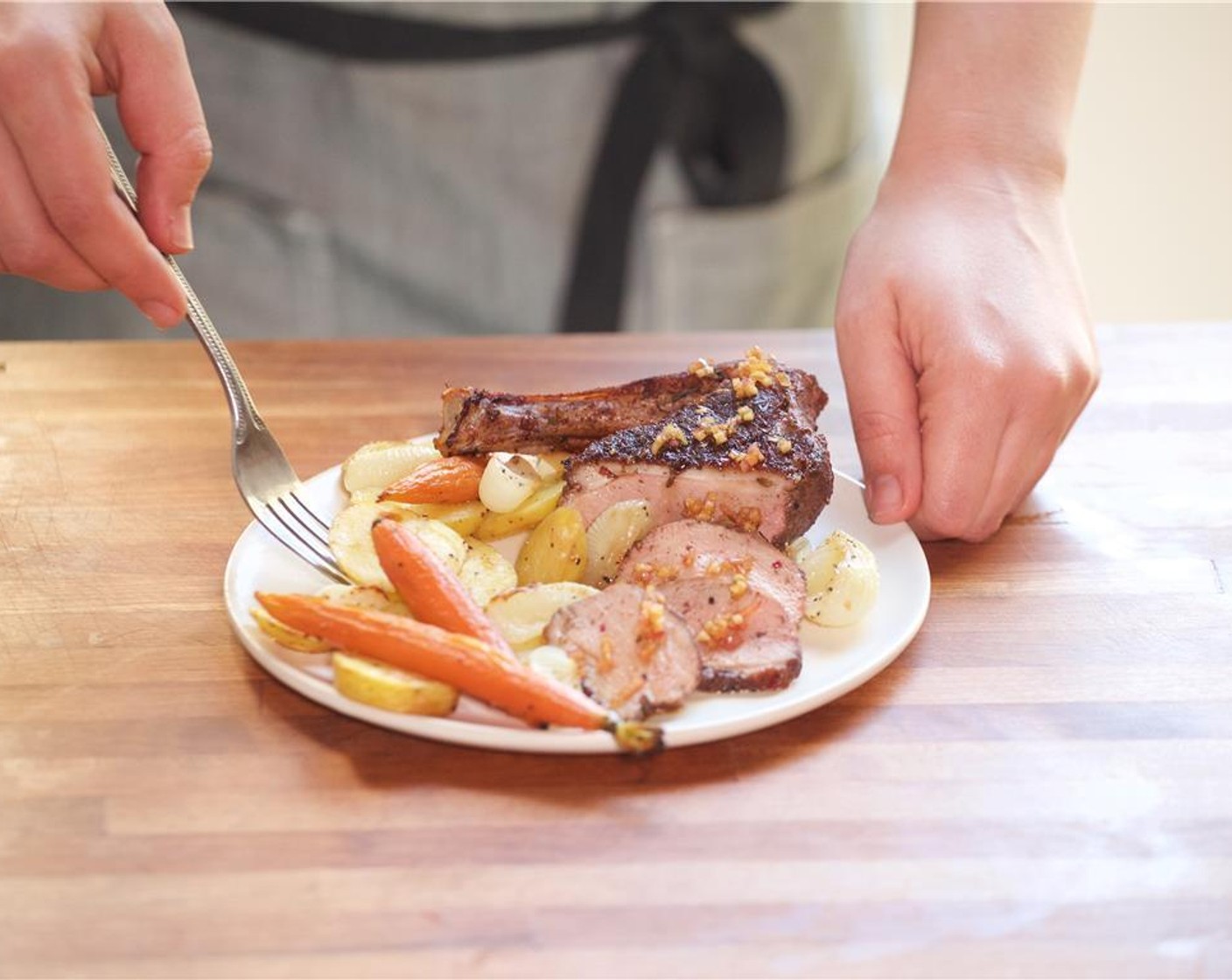 step 19 In the center of two plates, place the potatoes, cipollini onions, and carrots. Place the duck over the vegetables. Spoon sauce over the duck.