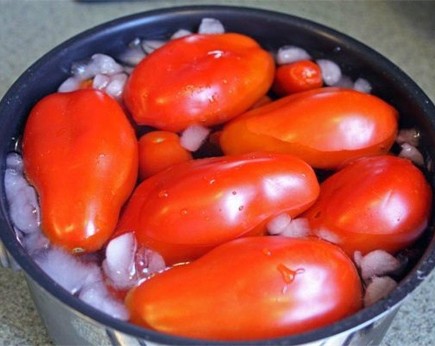 step 4 Remove the tomatoes from the boiling water and place into the ice bath for 1-2 minutes. The skins should start to visibly shrink.