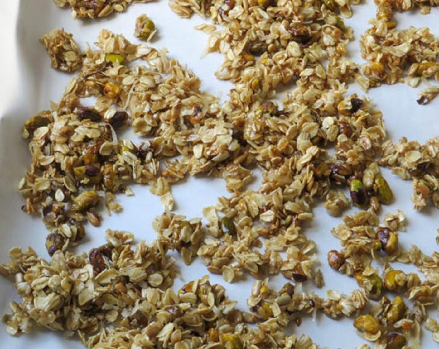 step 6 Divide the granola between the two sheet pans and spread it out into a single layer. Bake for 10 minutes, stir the granola and arrange in a single layer again.