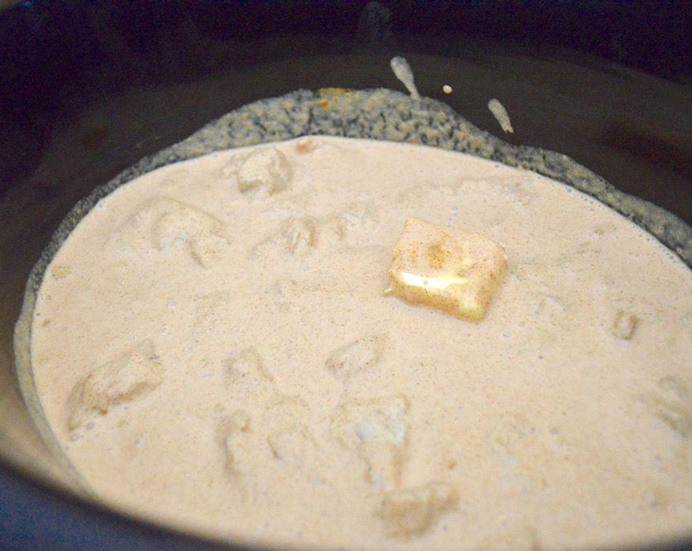 step 3 Cut it into large cubes and transfer it into a slow cooker. Add Butter (2 Tbsp) into the slow cooker with the chicken.