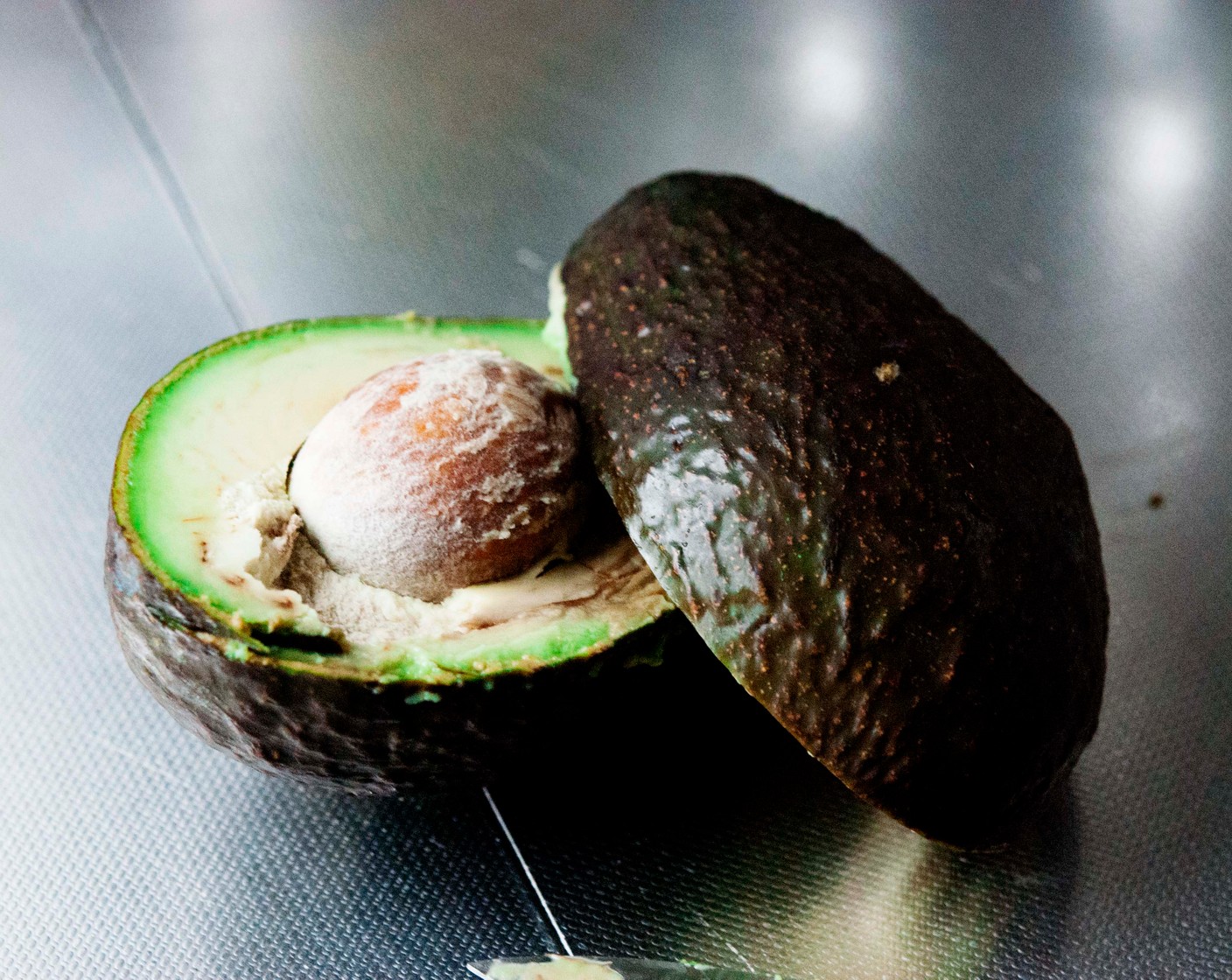 step 2 Remove the skin and central pit from the Avocado (1). Transfer it into the bowl of your electric mixer with Coconut Oil (1 Tbsp) and stir until creamy.