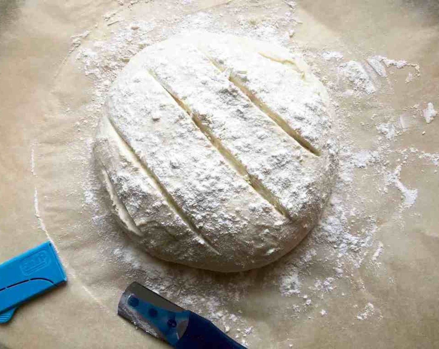 step 13 Just before baking, dust the top of the loaf generously with flour. (That will prevent the knife from sticking.) Slash a half-inch-deep cross, tic-tac-toe pattern, or slightly curved stripes into the top. You can use the tip of a serrated bread knife or a bread lame for slashing your markings. Leave the excess flour in place for baking; it can be brushed off before serving if desired.