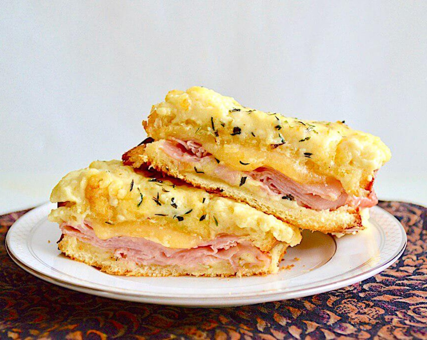 step 5 Finally, sprinkle a pinch of Herbes de Provence (2 pinches) on top of each sandwich. Bake them for 10-15 minutes until golden and bubbly. Serve immediately and enjoy!