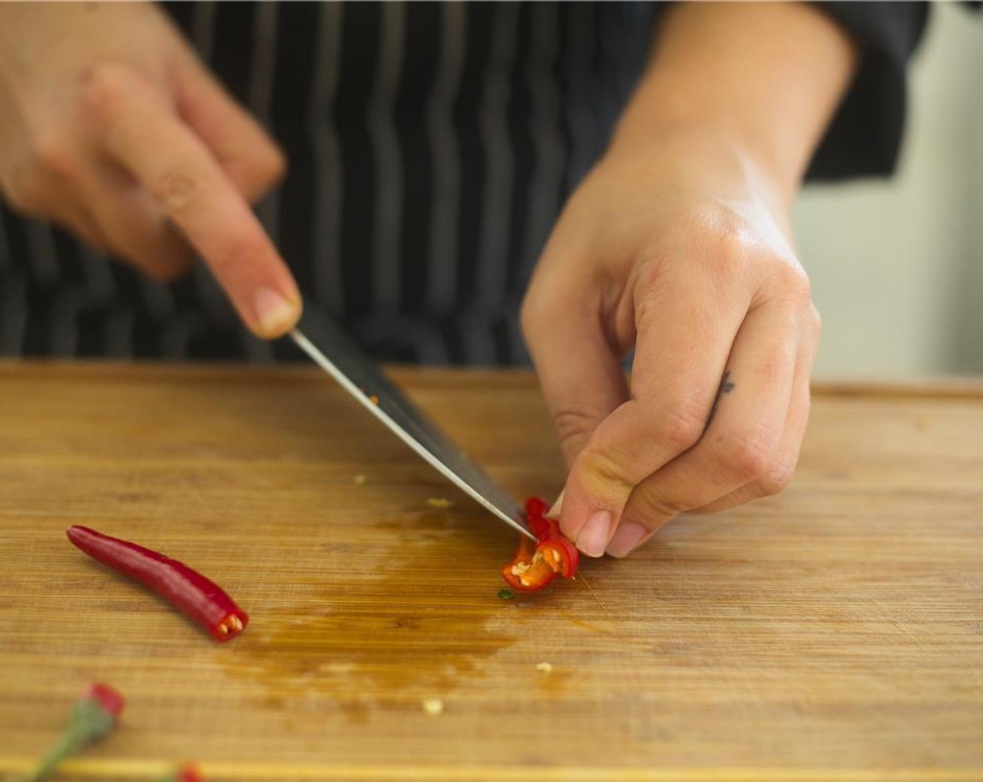 step 5 Cut Thai Chili Peppers (2) in half lengthwise. Discard seeds, stems, and discard stems, and add to bowl.