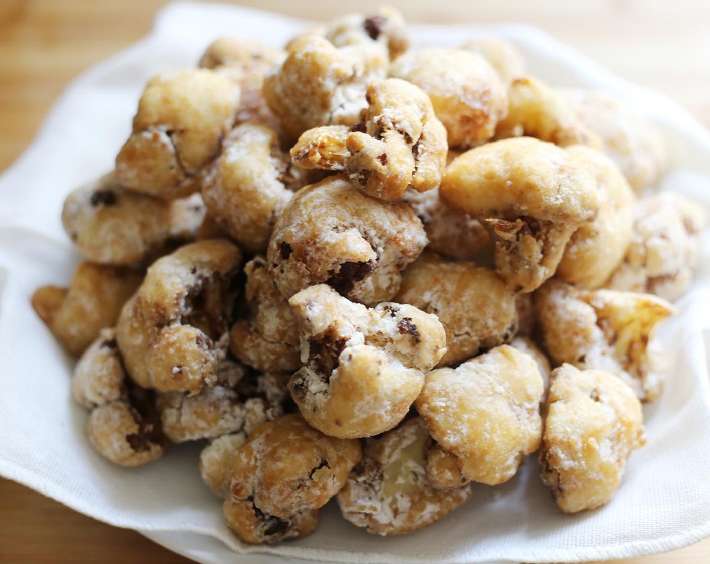 step 10 Carefully remove cauliflower florets from the oil and set on a dish lined with kitchen towel to absorb excess oil. Repeat until all the cauliflower is cooked.