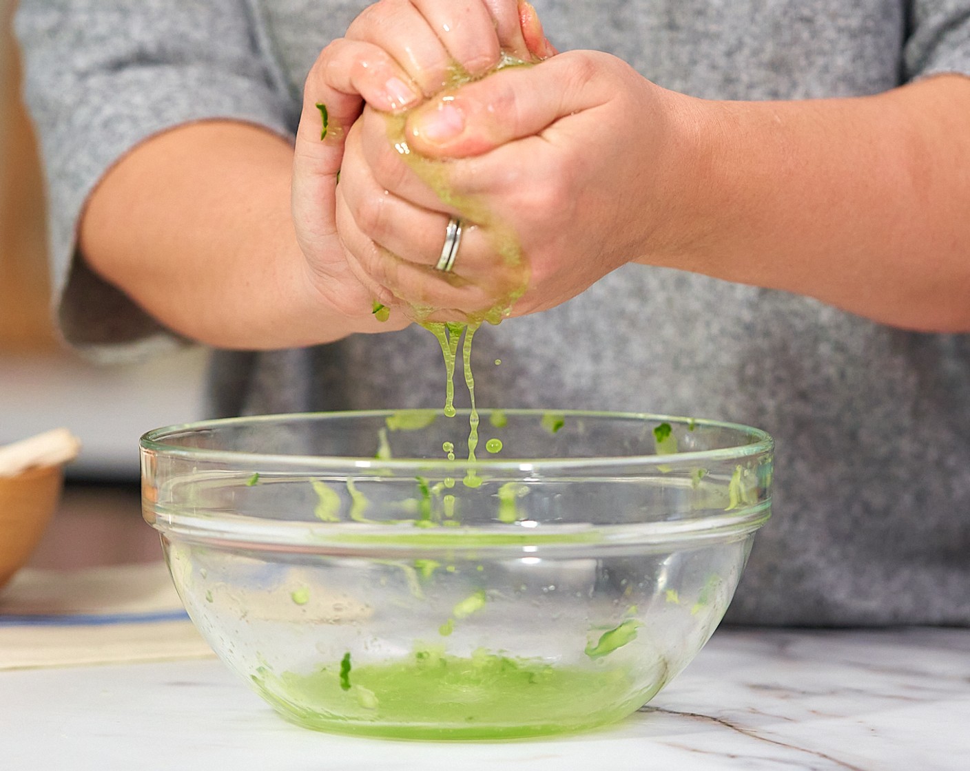 step 5 Use clean hands to squeeze out the extra liquid, then drain the liquid and return the cucumber to the bowl.