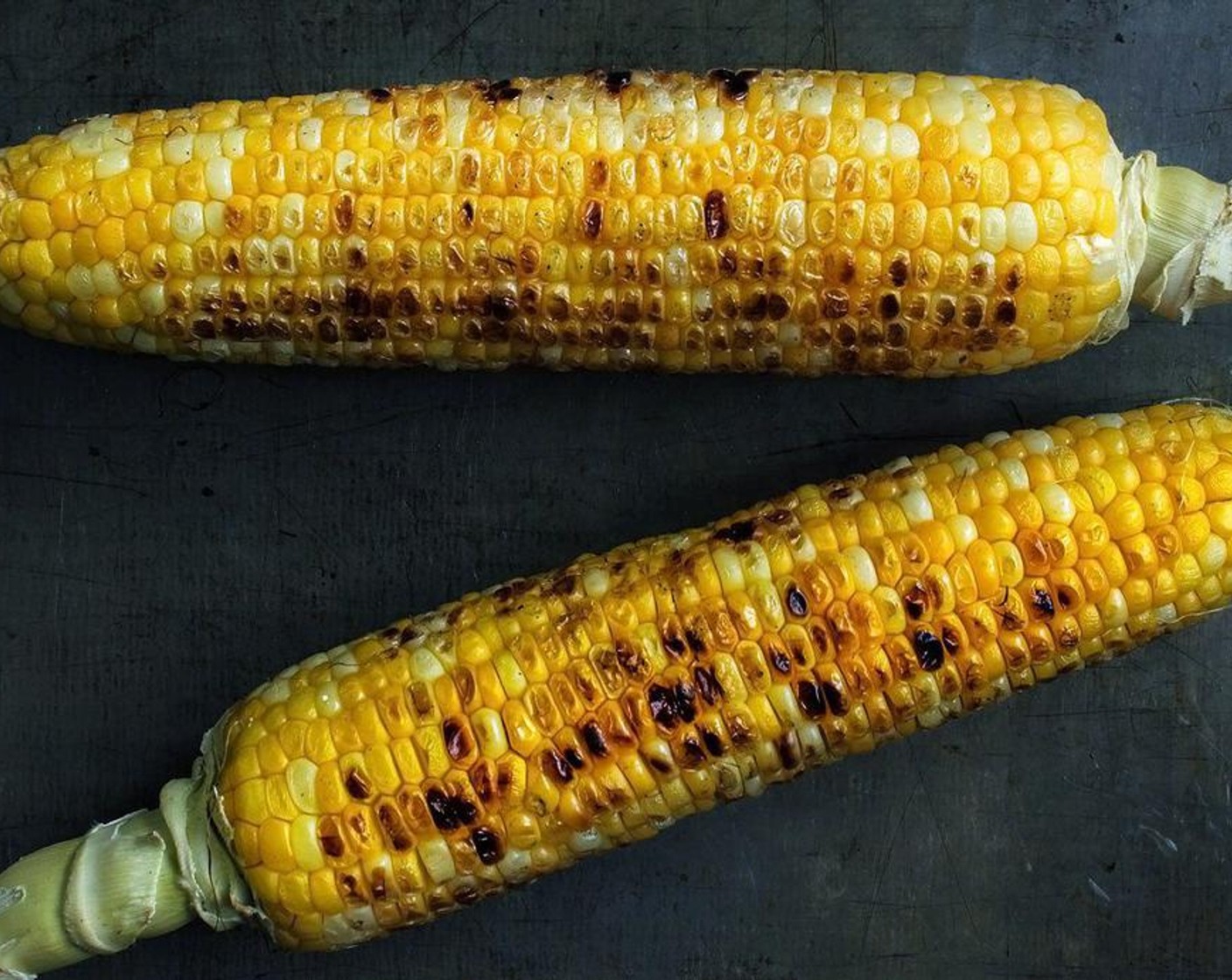 step 2 Brush the corn with a bit of oil and grill or broil the corn on high heat until brown and charred.
