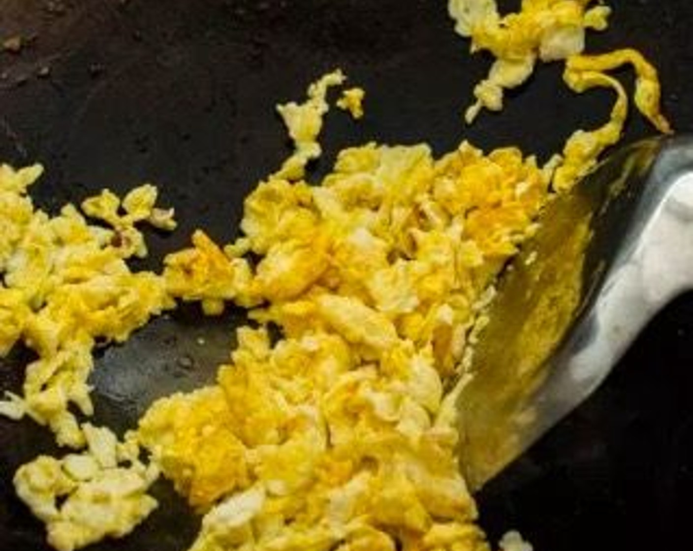 step 2 Add Cooking Oil (1 Tbsp) to the wok, followed by the Eggs (2). Allow the eggs to set, about 30 seconds, then scramble the eggs with your wok spatula. Remove the eggs from the wok and set aside.