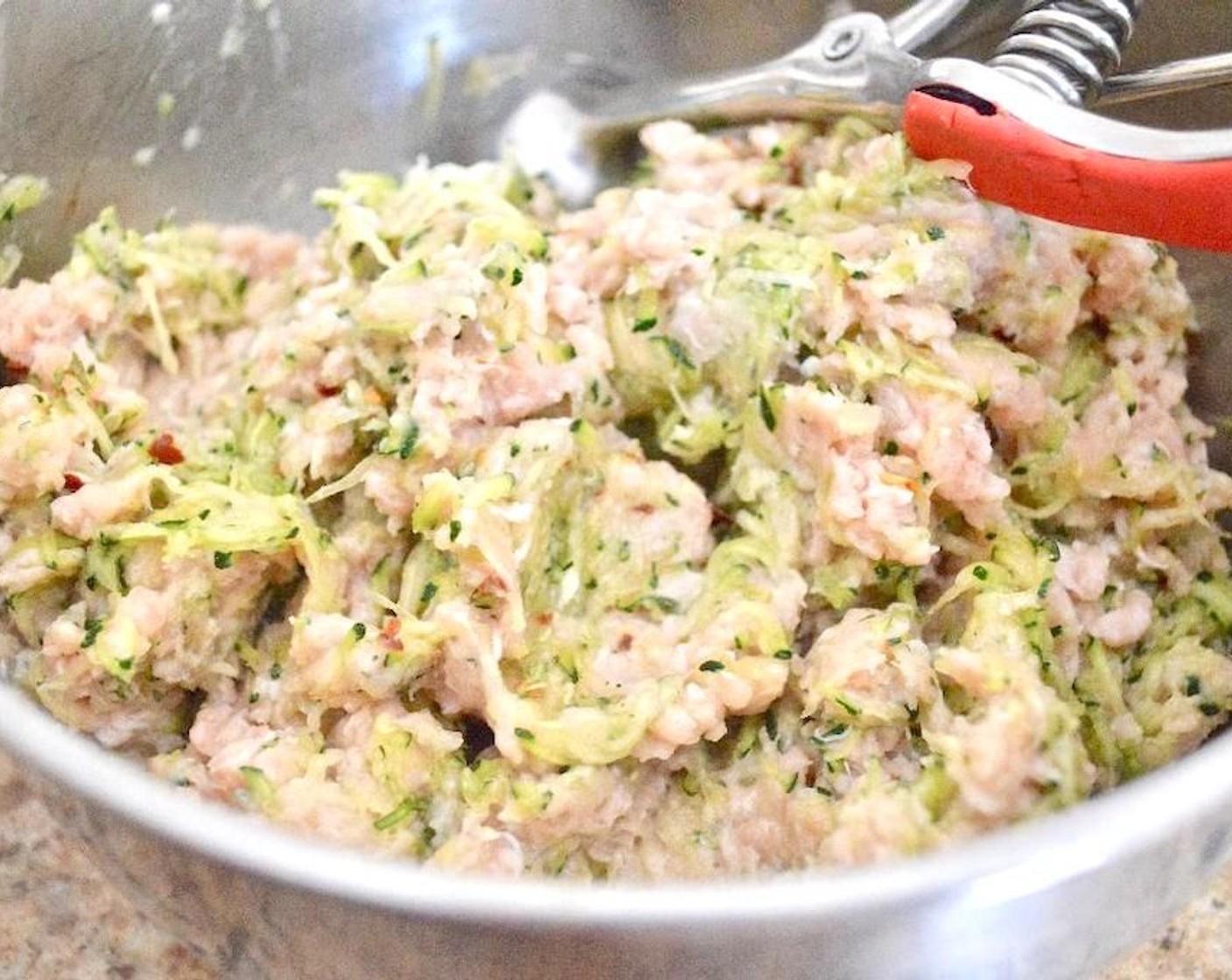 step 3 Combine zucchini, Ground Chicken (1 lb), Dijon Mustard (1 tsp), Salt (1/2 tsp), McCormick® Garlic Powder (1/2 tsp), Dried Onions (1/2 tsp), Dried Parsley (1/2 tsp), and Crushed Red Pepper Flakes (1/2 tsp) in a large bowl and stir it together thoroughly.