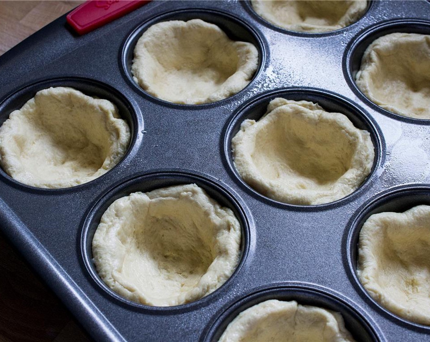 step 2 Spray muffin tins with canola oil, and flatten out each piece of the Buttermilk Biscuits (10 pieces) until it's 3 inches in diameter. Press each flattened biscuit into the muffin tin to form a cup. Bake according to directions.