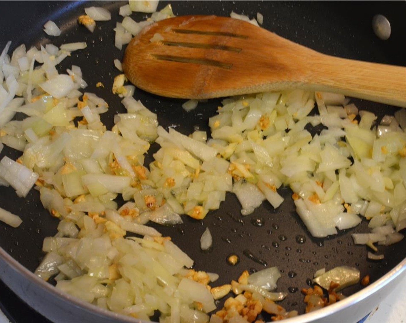 step 2 Heat the Extra-Virgin Olive Oil (2 Tbsp) in a deep fry pan and sauté the garlic and onion till soft.