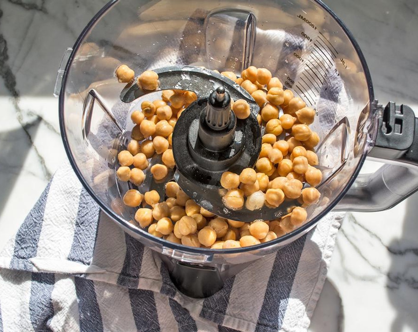 step 2 Add Chickpeas (1 can) to bowl of food processor. Pulse 2-3 times or until chickpeas are well ground, but not quite pureed.