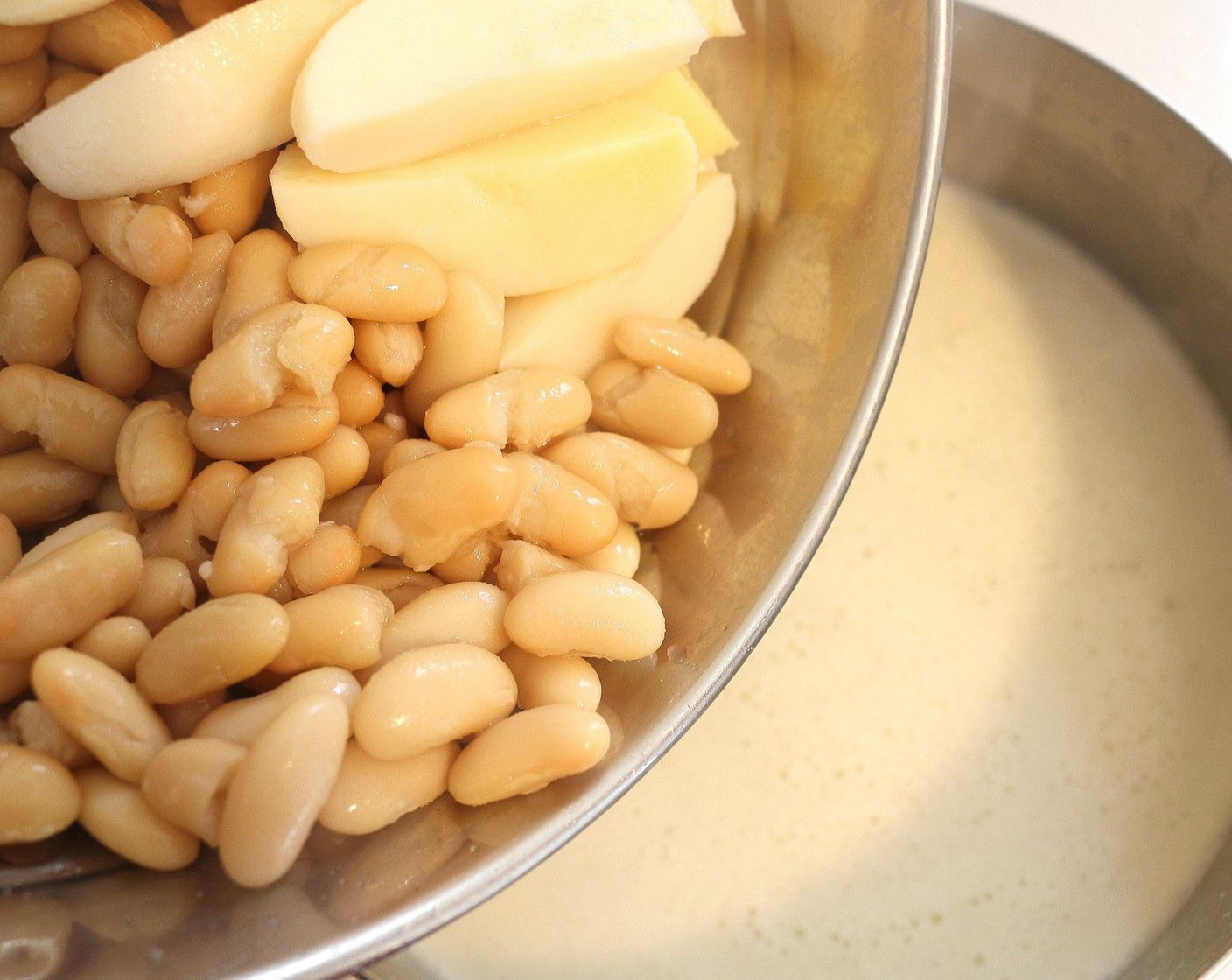 step 6 Add Canned Cannellini White Kidney Beans (1 cup), potato wedges, Scallions (2 Tbsp), bring to a simmer, cook for 2 more minutes; check/adjust seasoning.