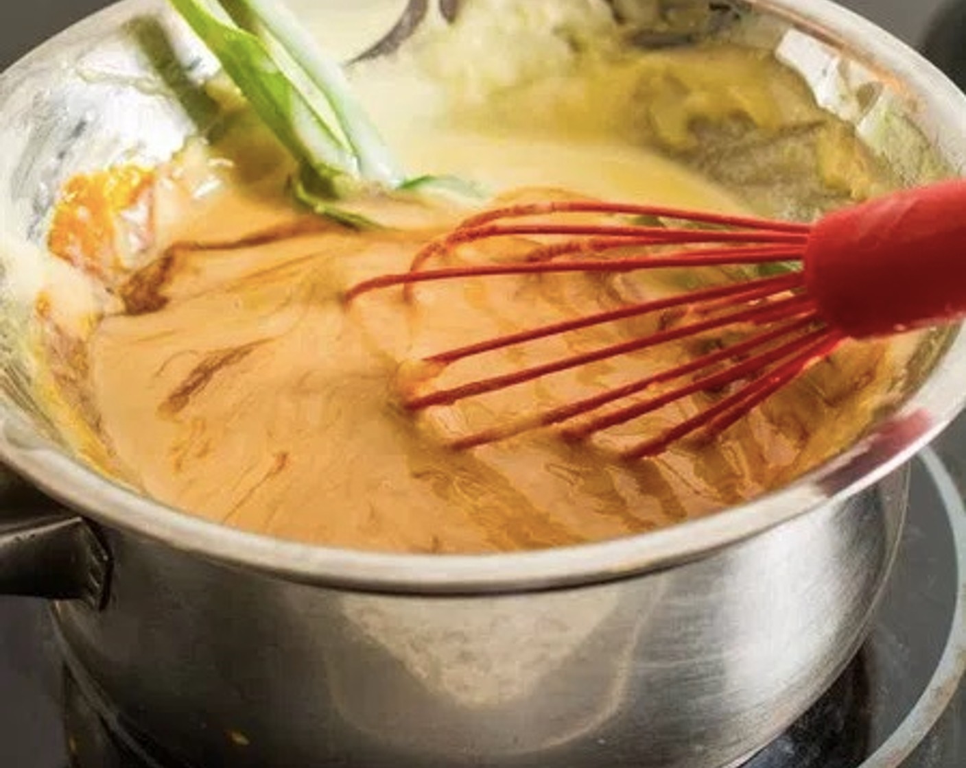 step 7 Place the bowl back on the saucepan, then place the saucepan over medium-low heat. Continue cooking the kaya for an additional 5 - 10 minutes, whisking frequently.