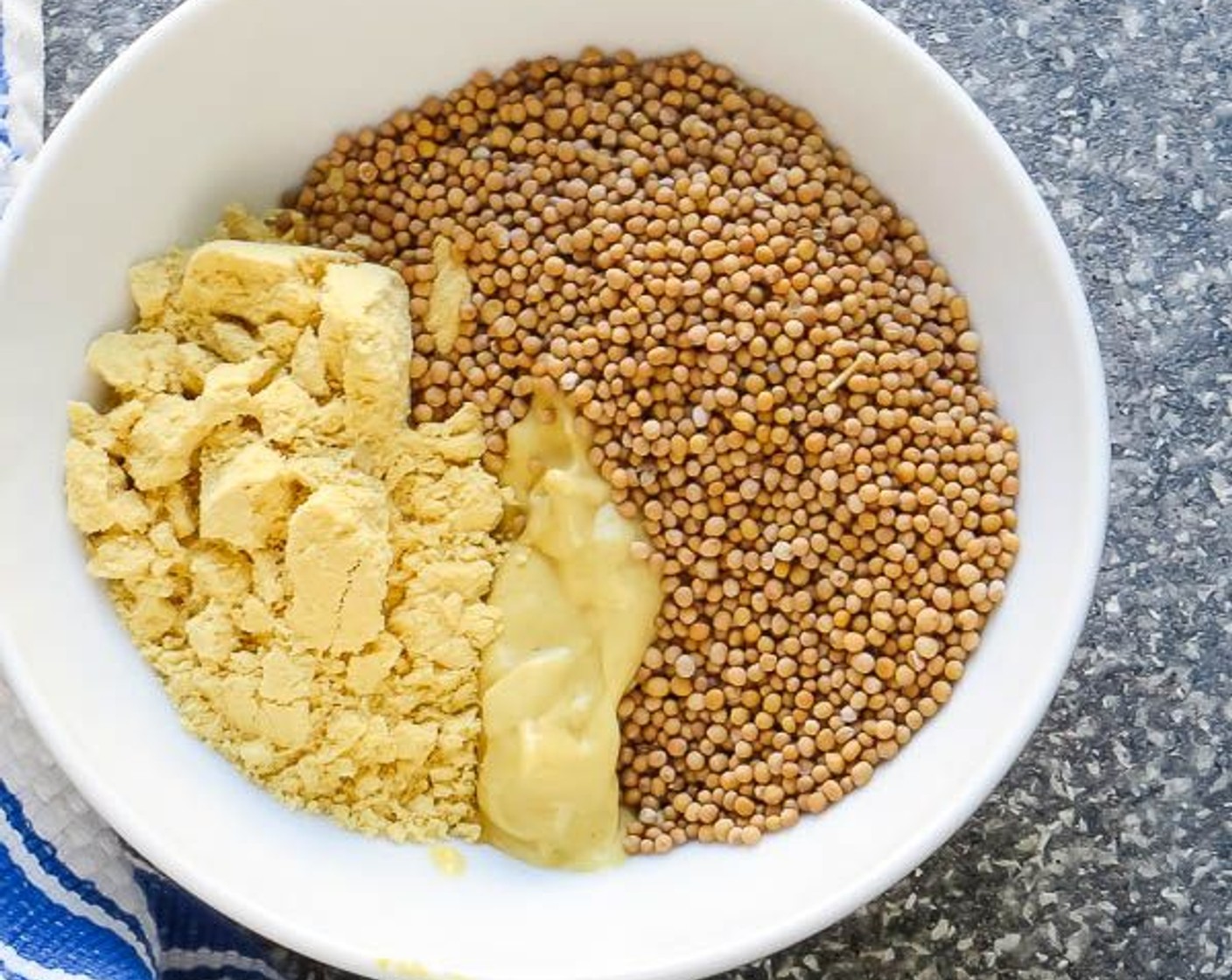 step 2 Combine the Dijon Mustard (3 Tbsp), Dry Mustard (2 Tbsp) and Mustard Seeds (1/4 cup) in a small bowl and stir. Add to the butter mixture.