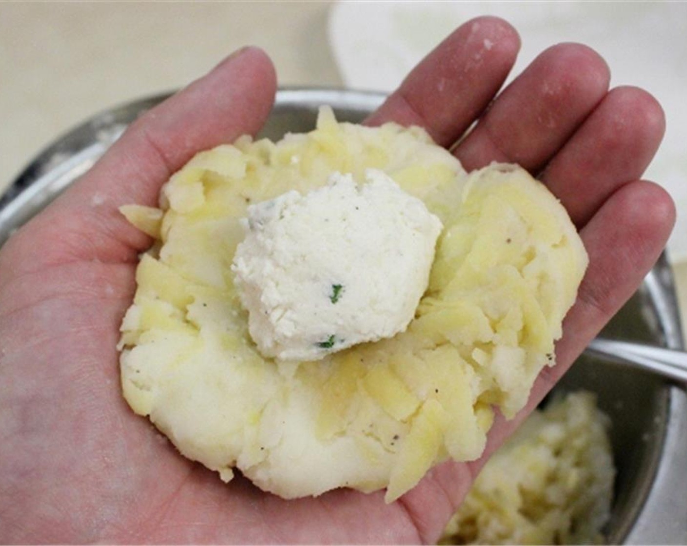 step 4 Take a 1/4 cup of the potato mixture to form a patty. Place a tablespoon of the cheese filling at the center of the patty.