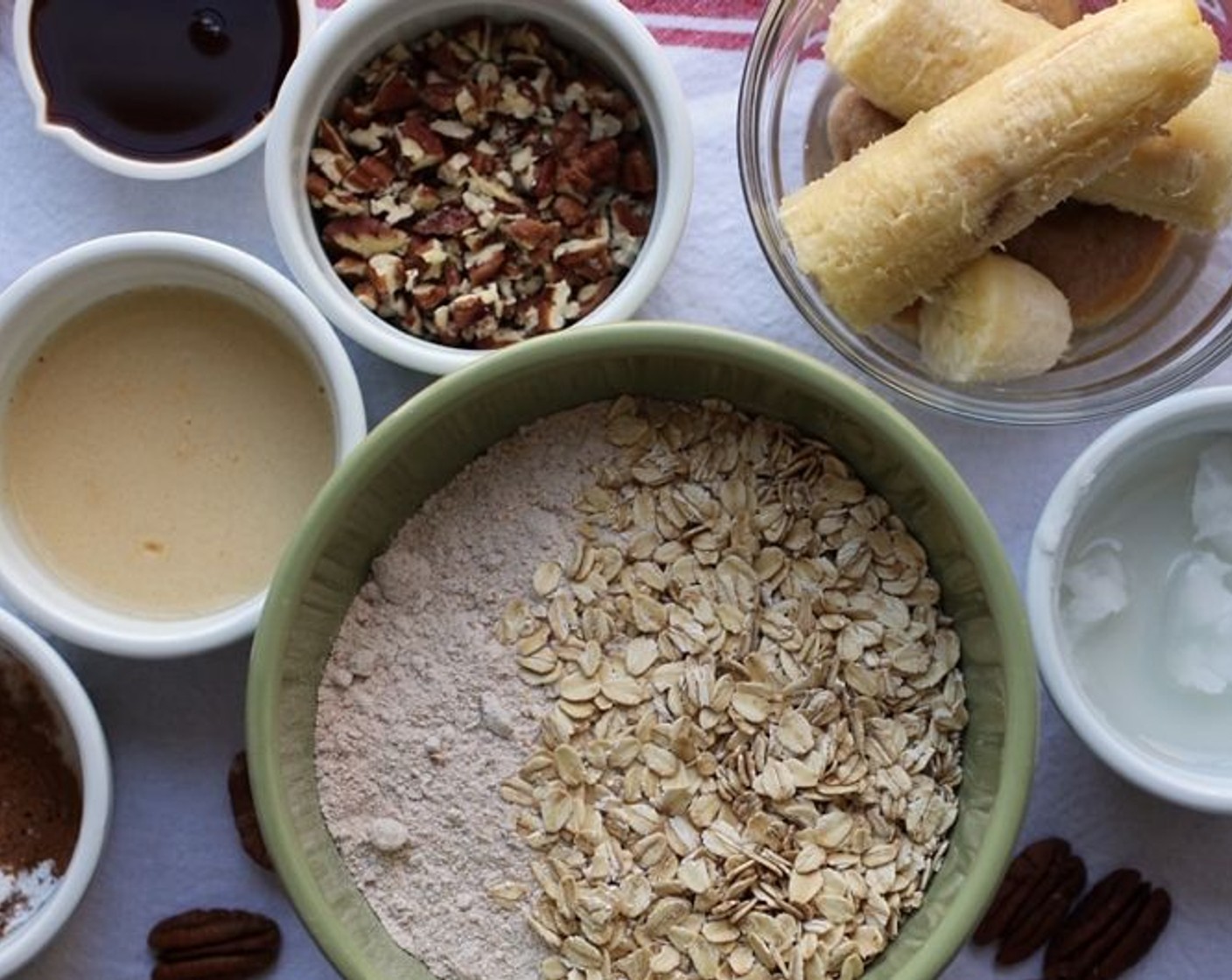 step 2 Mix together Whole Wheat Flour (1 1/2 cups), Old Fashioned Rolled Oats (1/2 cup), Baking Powder (1/2 Tbsp), Ground Cinnamon (1/2 tsp), Ground Nutmeg (1/2 tsp),  Salt (1 dash) and Chopped Pecans (1/4 cup) in a mixing bowl.