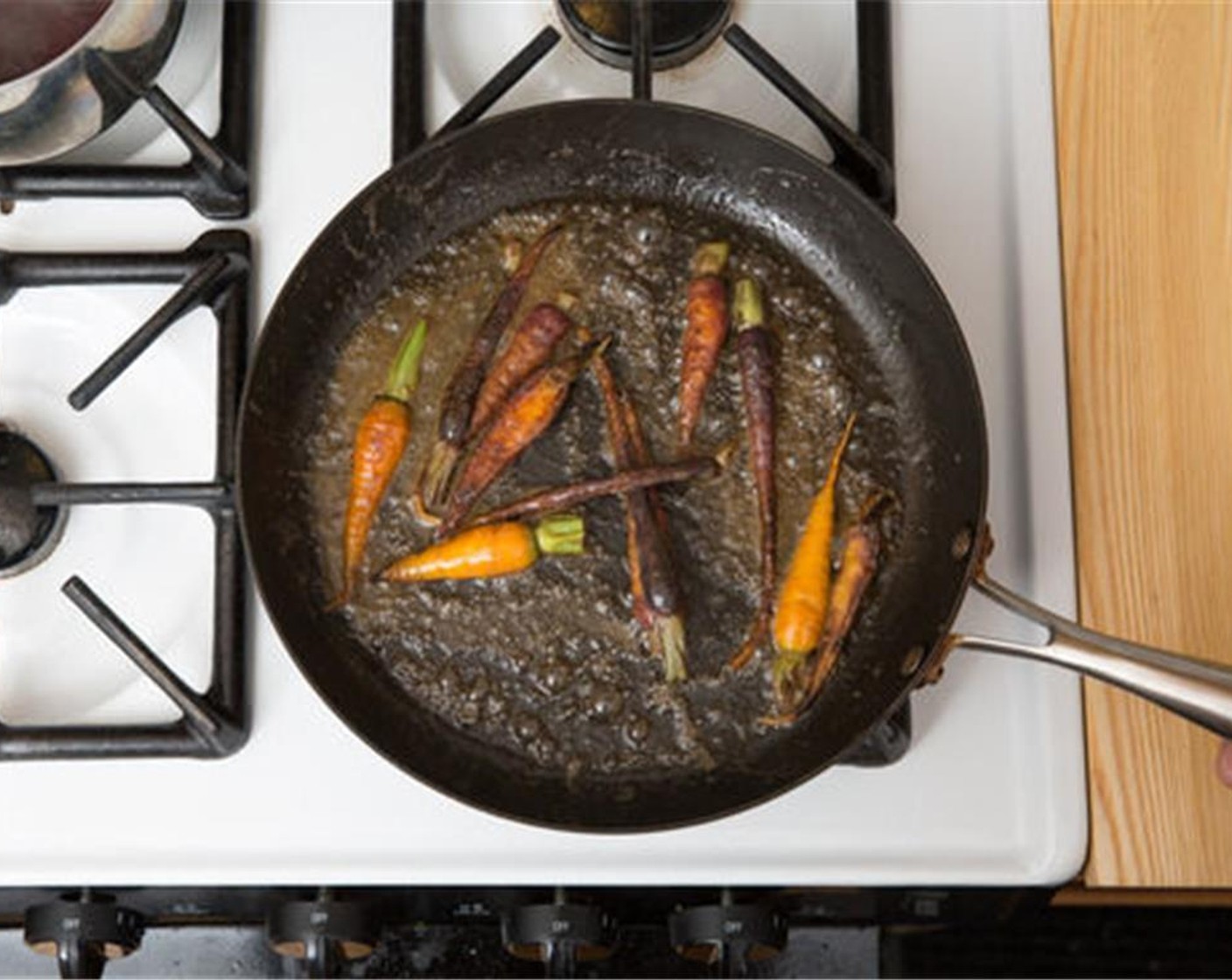 step 4 While the beets cook, in a large pan (nonstick, if you have one), heat Olive Oil (1/2 Tbsp) on medium-high until hot. Add the Heirloom Carrots (1/2 bunch) to cook, stirring occasionally, 4 to 6 minutes, or until slightly browned and tender.