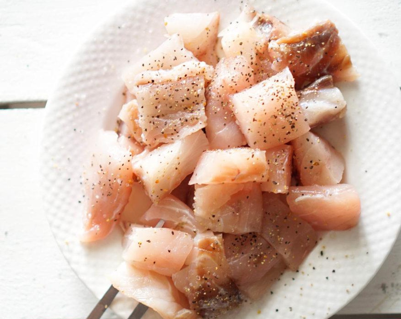 step 1 Cut Cod Fillets (4) into bite size pieces then sprinkle with Salt (to taste) and Ground Black Pepper (to taste).