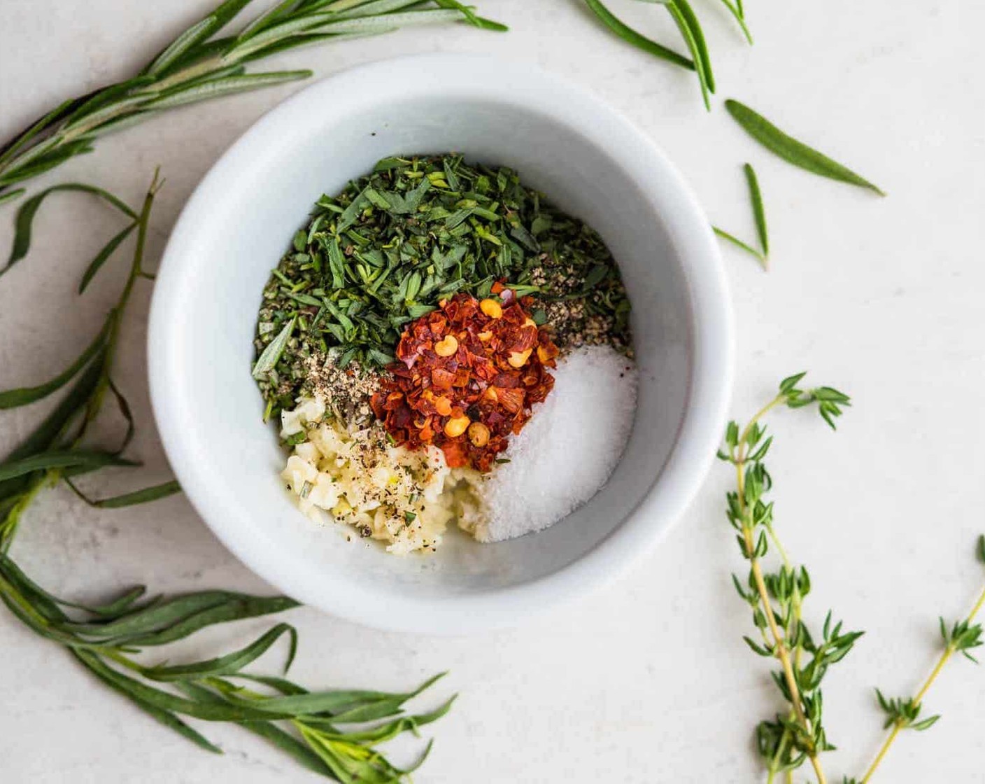 step 5 In a small bowl combine the Garlic (4 cloves), Fresh Thyme Leaves (1 Tbsp), Tarragon (1 Tbsp), Fresh Rosemary (1/2 Tbsp), Crushed Red Pepper Flakes (1/2 tsp), Kosher Salt (1 tsp), and Freshly Ground Black Pepper (1/2 tsp).