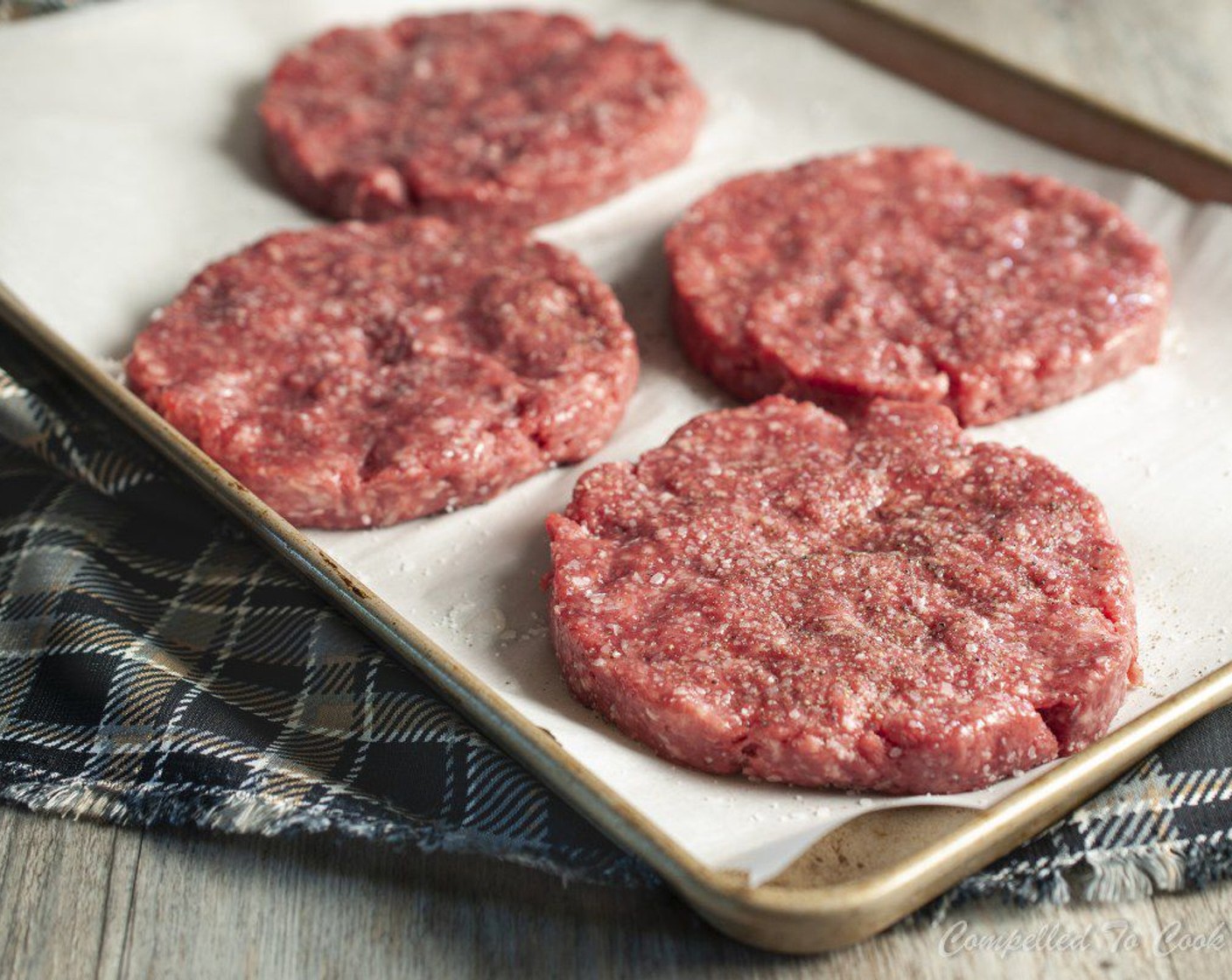 step 11 Place formed patties onto a parchment-lined tray and lightly brush both sides with Canola Oil (as needed). Sprinkle both sides generously with Kosher Salt (to taste) and Freshly Ground Black Pepper (to taste).