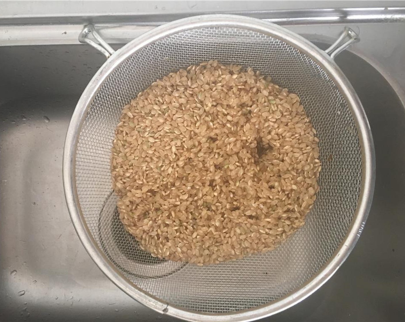 step 1 Rinse the uncooked Brown Rice (2 cups) in a strainer, until the water is clear.