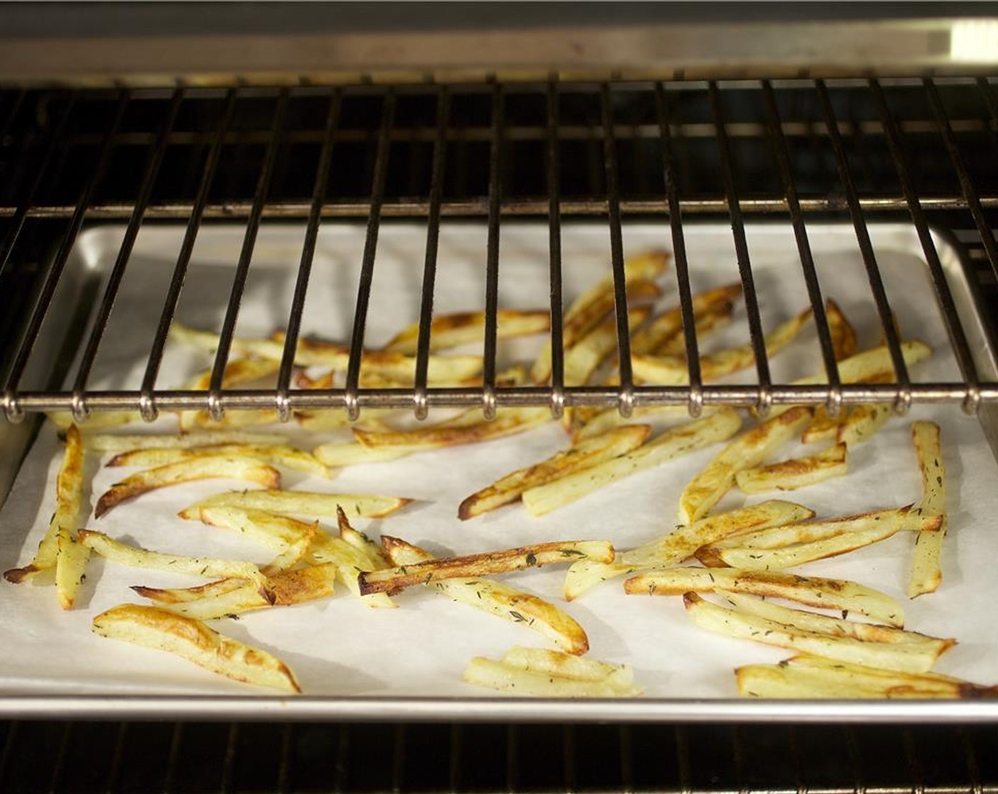 step 5 Place the potatoes in a single layer onto a sheet pan lined with parchment paper and bake for 30 minutes until golden brown. Rinse and dry bowl.