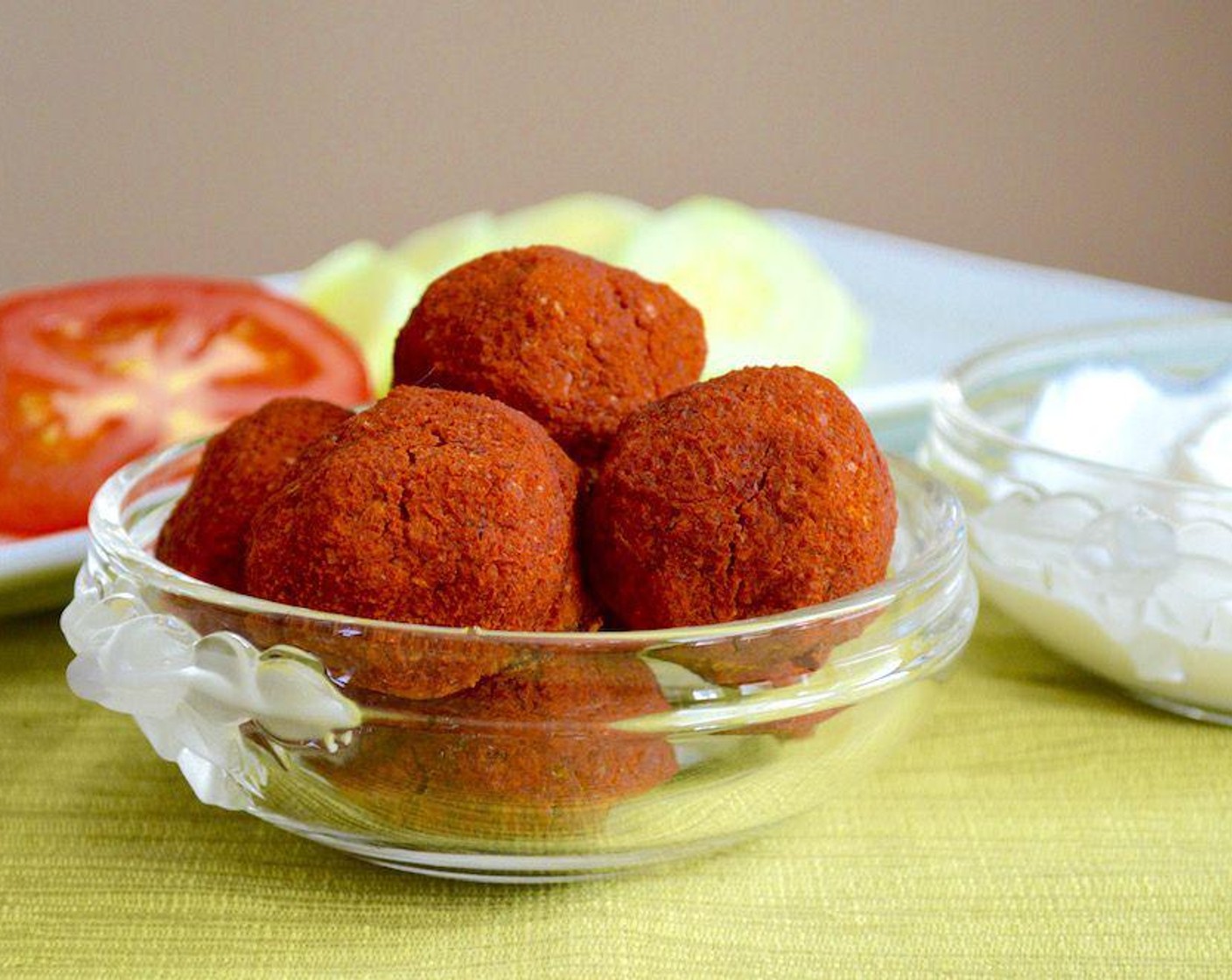 step 5 Bake the falafel for 25 minutes, until the outside is golden and crispy. Take the tray out when they're done and let them cool for a minute. Transfer them to a plate and serve with Greek Yogurt (as needed), Pita Bread (as needed), Tomatoes (as needed), and Cucumbers (as needed), if you wish for a wonderful vegetarian sandwich! Enjoy!