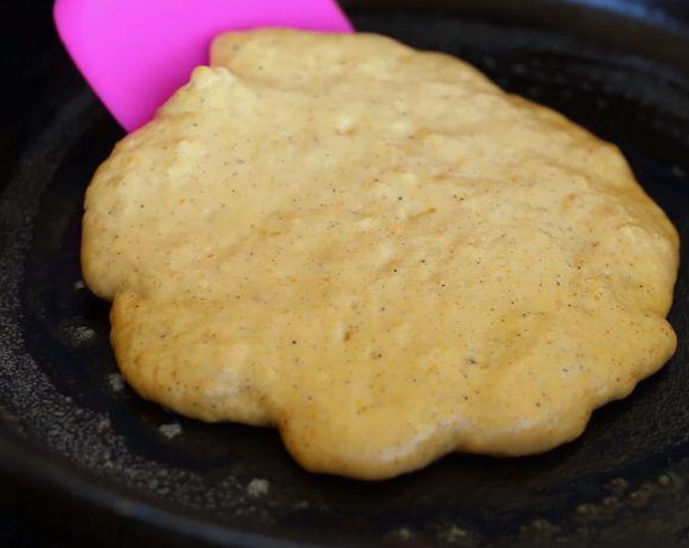 step 3 Butter a skillet or griddle, pour batter about 1/3 cup at a time onto the pan. Spread pancakes outward just slightly with bottom of measuring cup. Cook until golden brown on bottom then flip and cook opposite side until golden.