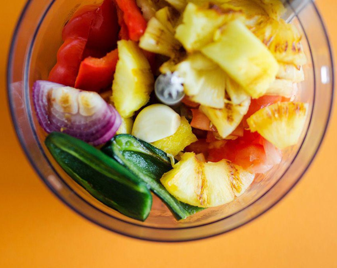 step 2 For chunky salsa, roughly chop Pineapple, Red Bell Pepper, Small Red Onion, Jalapeño, Tomatoes (2), Garlic (1 clove) and toss with Salt (1/4 tsp) and Ground Cumin (1/4 tsp). For less chunky salsa, throw everything in a food processor and blitz a few times until it reaches a consistency to your liking.