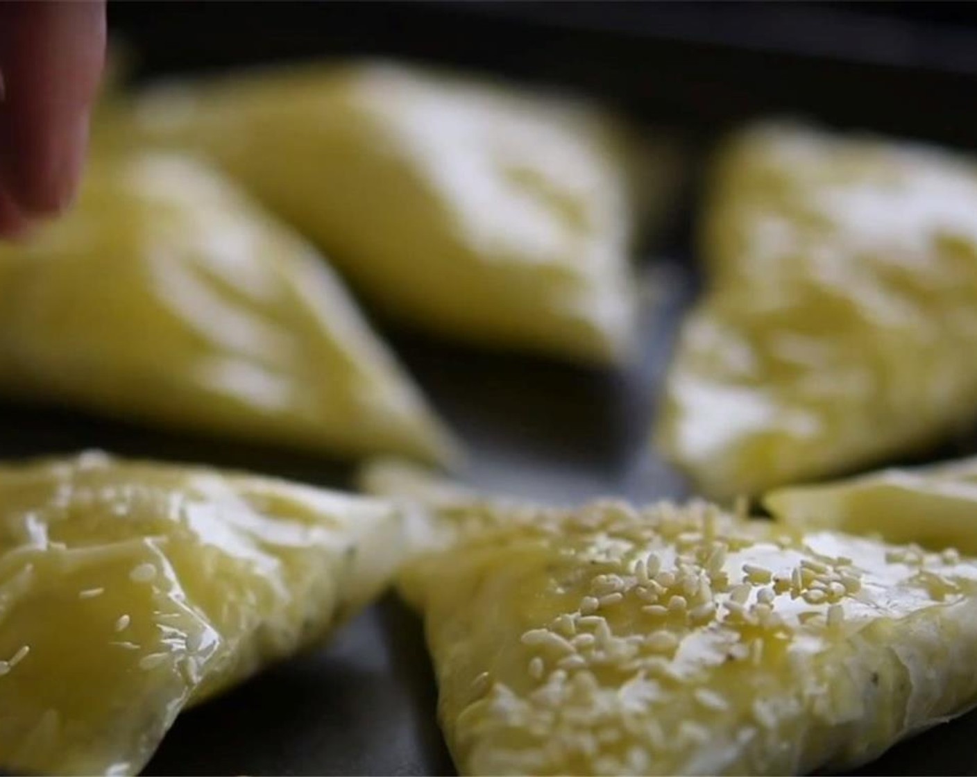 step 5 Beat the remaining Egg (1), and brush over pies. Sprinkle with Sesame Seeds (2 Tbsp)