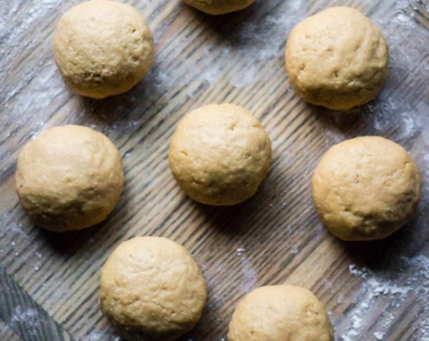 step 7 Once dough is risen, when you are ready to bake from refrigerated dough, grease an 8" baking pan, punch down the dough and on a floured work surface, divide the dough into 8 pieces.