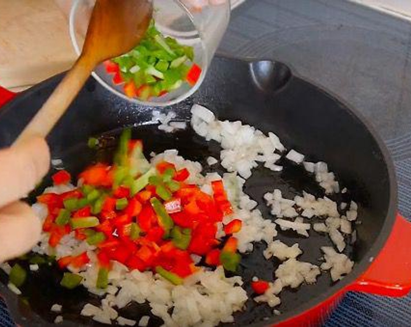 step 2 To a hot skillet add Vegetable Oil (3 Tbsp) add White Onion (1), Bell Pepper (1), and Garlic (2 cloves) and leave to cook until they start to soften.