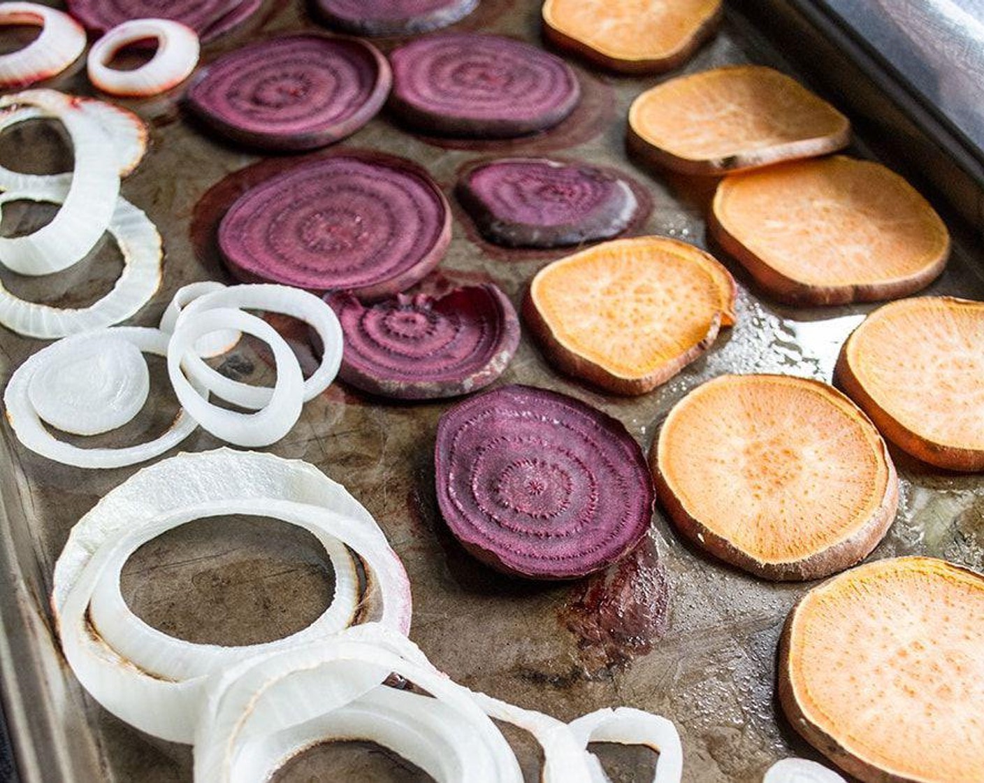 step 4 Lay out sweet potatoes, beets, and onion slices in single layer and bake for 18 minutes or until cooked through.