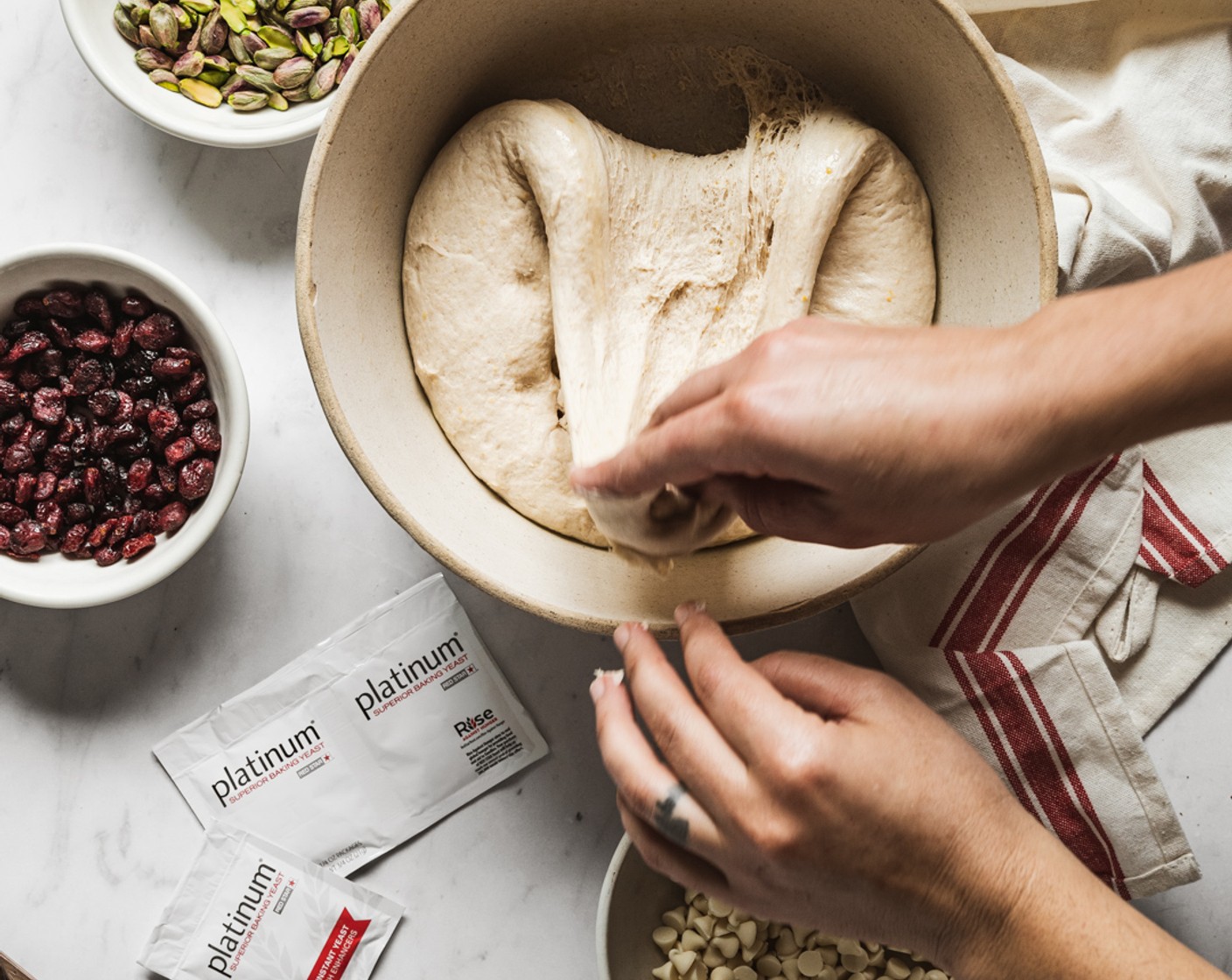 step 6 Using wet hands, fold the dough in the bowl by grabbing the underside of the dough, stretching it up, and folding it to the center of the dough. Do this 4 times around bowl.