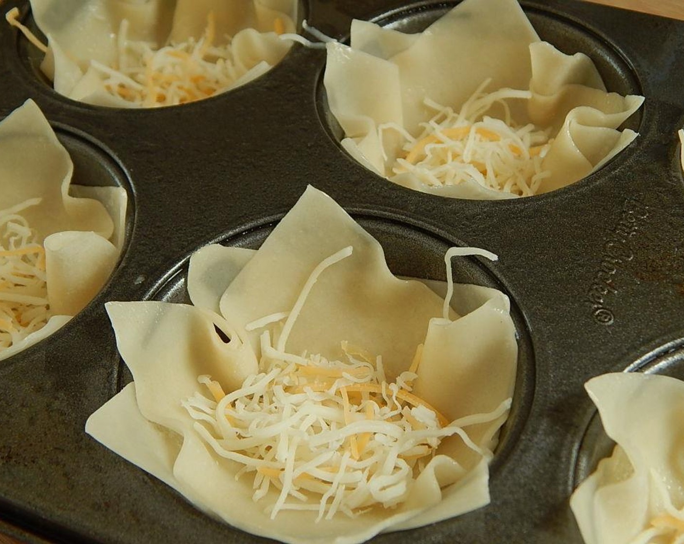 step 6 Use Light Shredded Cheese Blend (2 1/2 Tbsp) and sprinkle in the bottom of your wonton cups.