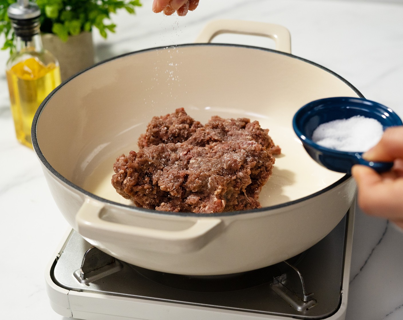 step 1 Heat Olive Oil (2 Tbsp) in a pot over medium-high heat. Once hot, add the Ground Beef (1 lb) and season right away with Salt (1/2 tsp) and Ground Black Pepper (1/2 tsp). After a few minutes, break it up and begin to stir, so you still have larger chunks with nice browning. Once it has just lost all its pinkness, remove the meat. Set aside.